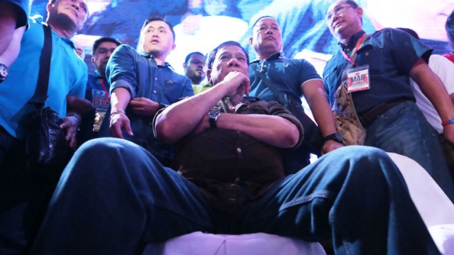 STRONG LEADER Presidential candidate and Davao City Mayor Rodrigo Duterte strikes a pose during the MAD for Change concert at McKinleyWest Open Field in Taguig City on Sunday night. GRIG C. MONTEGRANDE