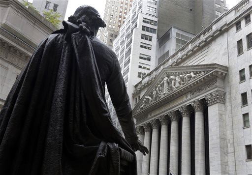  In this Oct. 2, 2014, file photo, the statue of George Washington on the steps of Federal Hall faces the facade of the New York Stock Exchange. Global stocks were mixed in light trading Monday, Dec. 28, 2015, as markets reopened following the Christmas break.  (AP Photo/Richard Drew, File)