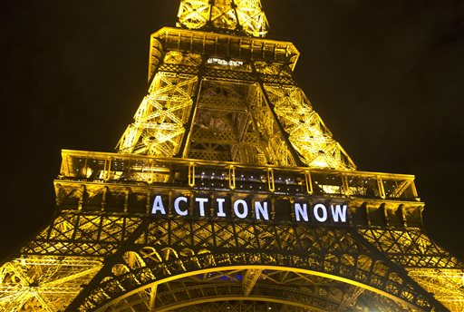In this Sunday, Dec. 6, 2015, photo, the Eiffel Tower lights up with the slogan"Action Now"referring to the COP21, United Nations Climate Change Conference in Paris. The carbon footprint for the COP21 conference runs to thousands of tons, for the some 40,000 people, including heads of state, negotiators, activists and journalists, in Paris to hash out a ground-breaking international agreement to put a brake on global warming. (AP Photo/Michel Euler)