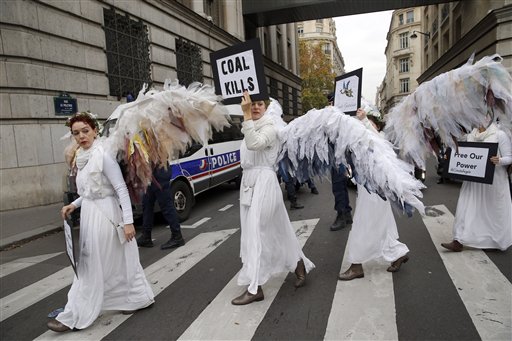 Activists of "Climacts Angels Guardians" from Australia arrive for a demonstration in Paris, Thursday, Dec. 3, 2015 . The protest is one of many activist actions linked to the COP21, the United Nations Climate Change Conference. (AP Photo/Christophe Ena)