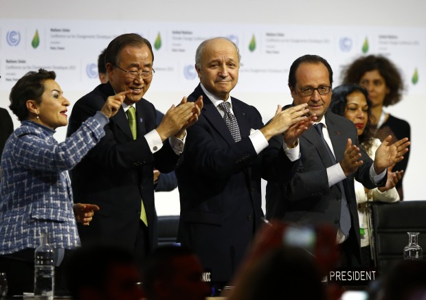 French President Francois Hollande, right, French Foreign Minister and president of the COP21 Laurent Fabius, second, right, United Nations climate chief Christiana Figueres and United Nations Secretary General Ban ki-Moon applaud after the final conference at the COP21, the United Nations conference on climate change, in Le Bourget, north of Paris, Saturday, Dec.12, 2015. Governments have adopted a global agreement that for the first time asks all countries to reduce or rein in their greenhouse gas emissions. (AP Photo/Francois Mori)