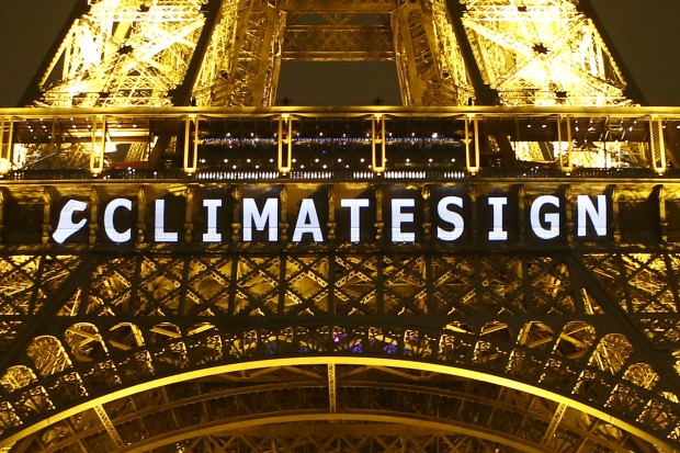 The slogan "CLIMATE SIGN" is projected on the Eiffel Tower as part of the COP21, United Nations Climate Change Conference in Paris, France, Friday, Dec. 11, 2015.  (AP Photo/Francois Mori)