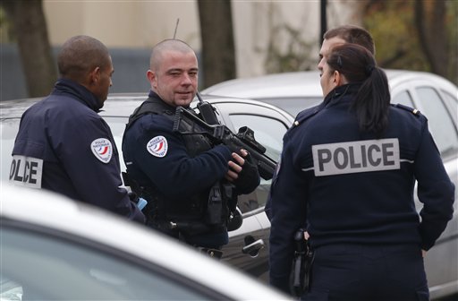 Police officers patrol near a pre-school, after a masked assailant with a box-cutter and scissors who mentioned the Islamic State group attacked a teacher, Monday, Dec.14, 2015 in Paris suburb Aubervilliers. The assailant remains at large, and the motive for the attack is unclear, authorities said. (AP Photo/Michel Euler)