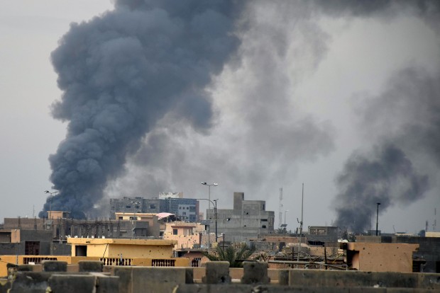 Smoke rises from Islamic State positions following a U.S.-led coalition airstrike as Iraqi Security forces advance their position in downtown Ramadi, 70 miles (115 kilometers) west of Baghdad, Iraq, Tuesday, Dec. 22, 2015. The advance of government forces in the Islamic State-held city of Ramadi is being hampered by suicide bombers, snipers and booby traps, Gen. Ismail al-Mahlawi, the head of Iraqi military operations in Anbar said. (AP Photo)