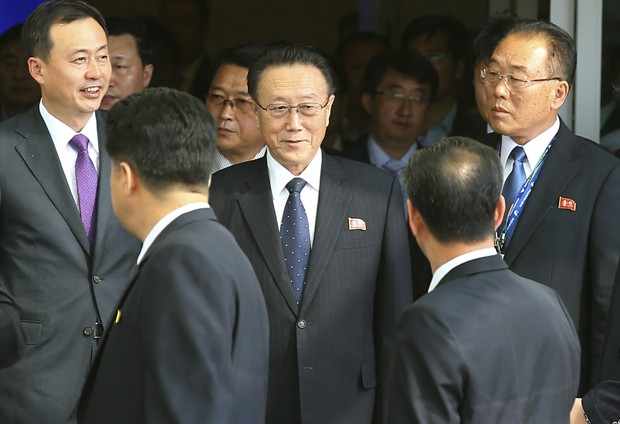 FILE - In this Oct. 4, 2014 file photo, Kim Yang Gon, center, a secretary of North Koreas ruling Workers' Party, arrives at the Incheon International Airport in Incheon, South Korea.  The North Korea's top official in charge of relations with South Korea has died of a car accident, the Korean Central News Agency announced Wednesday, Dec. 30, 2015. He was 73. (Kim Do-hoon/Yonhap via AP, File) KOREA OUT