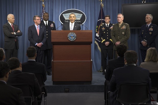 President Barack Obama, accompanied by Defense Secretary Ash Carter and Commander of U.S. Central Command Gen. Lloyd Austin, speaks at the Pentagon, Monday, Dec. 14, 2015, about the fight against the Islamic State group following a National Security Council meeting. The president said the U.S. military and allied forces are hitting the Islamic State group harder than ever. He is joined by, from left, Vice President Joe Biden, Defense Secretary Ash Carter, Commander of U.S. Central Command Gen. Lloyd Austin, Commander of U.S. Special Operations Command Gen. Joseph Votel, Joint Chiefs Chairman Gen. Joseph Dunford, and Joint Chiefs Vice Chairman Gen. Paul Selva. (AP Photo/Evan Vucci)