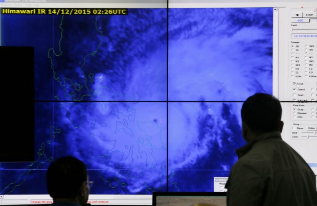 Government meteorologists monitor from a satellite image of Typhoon Melor fat the weather bureau center in suburban Quezon city, northeast of Manila, Philippines as it hits the eastern Philippines Monday, Dec. 14, 2015. Thousands of residents evacuated as the typhoon slammed into the eastern Philippines, where flood- and landslide-prone communities are bracing for destructive winds, heavy rains and coastal floods of up to 4 meters (13 feet), officials said Monday. (AP Photo/Bullit Marquez)