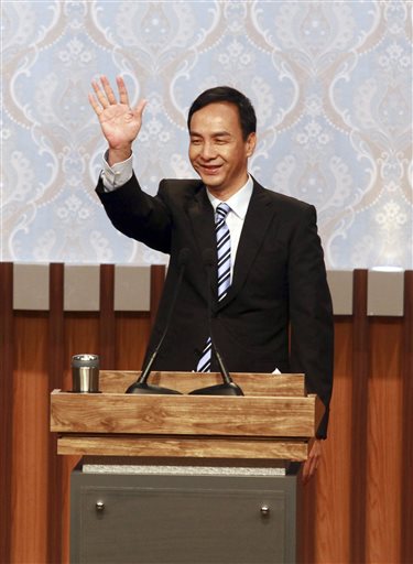 Taiwan's ruling KMT or Nationalist Party 2016 presidential candidate Eric Chu waves before his first televised policy debate with the Democratic Progressive Party's, or DPP, Tsai Ing-wen and People First Party's James Soong in Taipei, Taiwan, Sunday, Dec. 27, 2015. Taiwan will hold its general elections on Jan. 16, 2016. AP