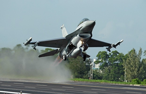 FILE - In this Sept. 16, 2014 file photo, a Taiwan Air Force F-16 fighter jet takes off from a closed section of highway during the annual Han Kuang military exercises in Chiayi, central Taiwan. China on Wednesday, Dec. 16, 2015 strongly criticized an expected U.S. arms sale to Taiwan, saying it should be canceled to avoid harming relations between Taipei and Beijing. (AP Photo/Wally Santana, File)