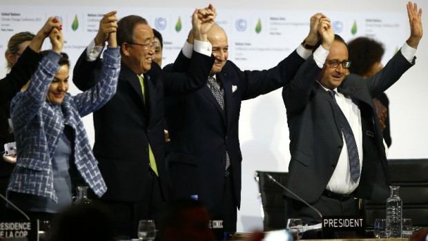 French President Francois Hollande, right, French Foreign Minister and president of the COP21 Laurent Fabius, second, right, United Nations climate chief Christiana Figueres and United Nations Secretary General Ban ki-Moon hold their hands up after the final conference at the COP21, the United Nations conference on climate change, in Le Bourget, north of Paris, Saturday, Dec.12, 2015. Governments have adopted a global agreement that for the first time asks all countries to reduce or rein in their greenhouse gas emissions. (AP Photo/Francois Mori)