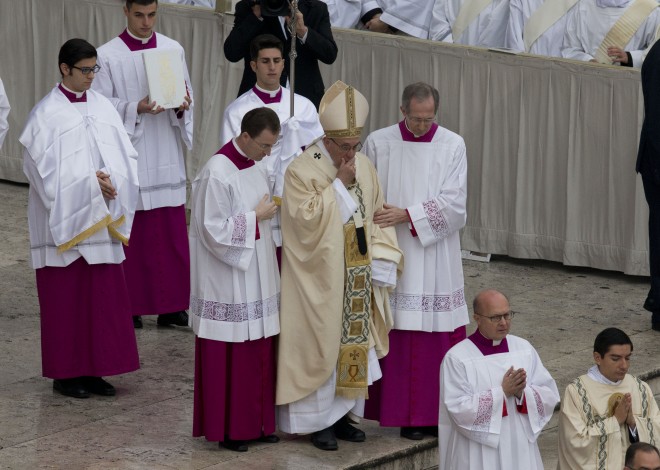Pope Francis, center, arrives to celebrate Mass ahead of the opening of the Holy Door of St. Peter's Basilica, formally starting the Holy Year of Mercy, at the Vatican, Tuesday, Dec. 8, 2015. Francis launched the 12-month jubilee to emphasize what has become the leitmotif of his papacy: to show the merciful and welcoming side of a Catholic Church more often known for its moralizing and judgment. (AP Photo/Alesssandra Tarantino)