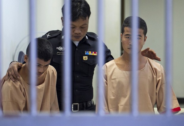 Myanmar migrants Win Zaw Htun, right, and Zaw Lin, left, both 22, are escorted by an official after their guilty verdict at court in Koh Samui, Thailand, Thursday, Dec. 24, 2015. A Thai court on Thursday sentenced the two Myanmar migrants to death for killing British backpackers David Miller, 24, and Hannah Witheridge, 23, on the resort island of Koh Tao last year, a crime that focused global attention on tourist safety and police conduct in the country. AP