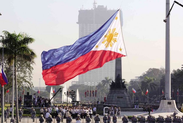 FLAG RAISING ON RIZAL DAY To commemorate the 119th anniversary of the martyrdom of the hero Dr. Jose Rizal, President Aquino led the flag-raising ceremony at Rizal Park in Manila for the last time in his six-year term.  In the background is the 42-story Torre de Manila condominium building that the Knights of Rizal wants dismantled for marring the vista of the Rizal Monument. NIÑO JESUS ORBETA
