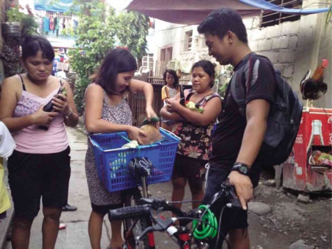 Mac Edsel Florendo (right, with backpack) collects unspoiled food from households in the city. One of Food Rescue Asean’s rationale is to cut food wastage in the country, starting in Dumaguete City, Negros Oriental.