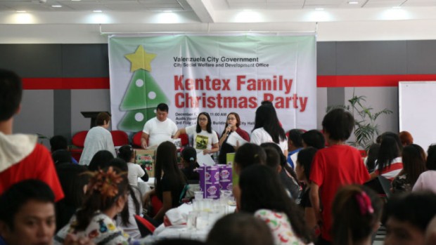 RELATIVES of workers who died in a fire that razed Kentex Manufacturing’s slipper factory in Valenzuela City inMay attend a Christmas party to remind them that life goes on despite the tragedy. JEREMIAH RUBIANO/VALENZUELA CITY PUBLIC INFORMATION OFFICE