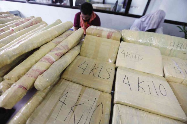 A MAN and his teenage son have a lot of explaining to do to authorities in Camp Crame, Quezon City, over their cargo of  dried marijuana leaves.   NIÑO JESUS ORBETA