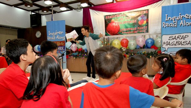 Reader Kyle Vergara of Starstruck reads the story of 'Isem, sa Bayang Bawal Tumawa' to  Children with Hemophilia and members ofHemophilia Advocates of the Philippines during Inquirer Read-Along session at the National Federation of Women's Club of the Philippines Building in Malate, Manila. INQUIRER PHOTO / RICHARD A. REYES