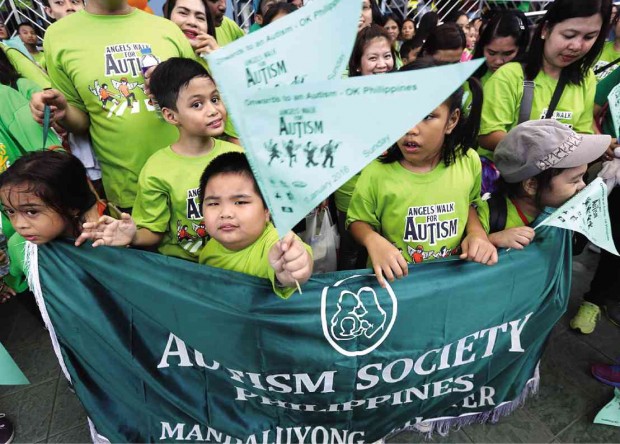WALK THEIR WAY Sunday’s “Angels Walk” at SM Mall of Asia renews the campaign for commercial establishments, workplaces and laws that extend compassion and opportunities to persons with autism. photos by MARIANNE BERMUDEZ