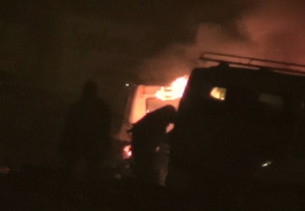 In this grab taken from video by Associate Press Television, two unidentified armed men approach a vehicle, near to a hotel,  in Ouagadougou, Burkina Faso, Friday, Jan. 15, 2016.  Attackers struck an upscale hotel popular with Westerners in Burkina Faso's capital late Friday, fueling the recent political turmoil in the West African country. Three hours later, gunfire could still be heard as soldiers in an armored vehicle finally approached the area. Associated Press Television