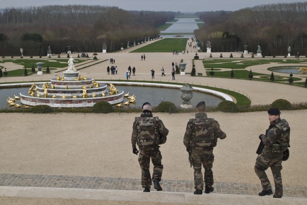 Soldiers patrol in the gardens of the Versailles Palace, west of Paris, Thursday, Dec. 24, 2015. Belgian authorities have announced the arrest of a ninth suspect linked to last month's Paris attacks, a man they said had been in contact with the suspected ringleader's cousin. (AP Photo/Michel Euler)