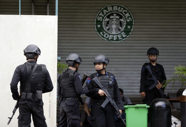 Indonesian police officers guard near the Starbucks cafe where Thursday's attack took place, in Jakarta, Indonesia, Saturday, Jan. 16, 2016. An audacious attack by suicide bombers in the heart of Indonesia's capital was funded by the Islamic State group, police said Friday, as they seized an IS flag from the home of one of the attackers and carried out raids across the country in which one suspected militant was killed. (AP Photo/Dita Alangkara)