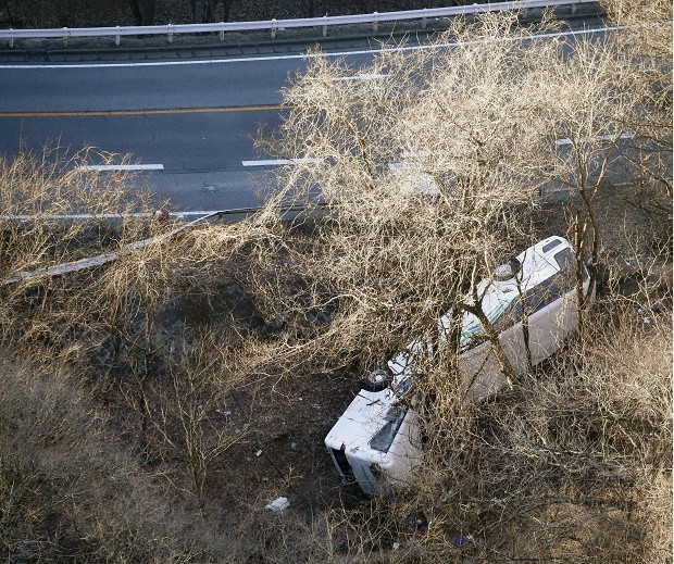 A bus lies after it veered off to the opposite lane on a mountain road in Karuizawa, Nagano prefecture, central Japan Friday, Jan. 15, 2016. Rescue officials say the overnight tour bus on its way to a ski resort in central Japan slid down the mountainside, killing at least more than a dozen passengers. AP 