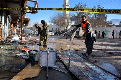 Pakistani security officials examine at the site of suicide bombing in Quetta, Pakistan, Wednesday, Jan. 13, 2016. The suicide attack on a polio vaccination center in southwestern Pakistan killed more than a dozen people and wounded many, officials said. (AP Photo/Arshad Butt)