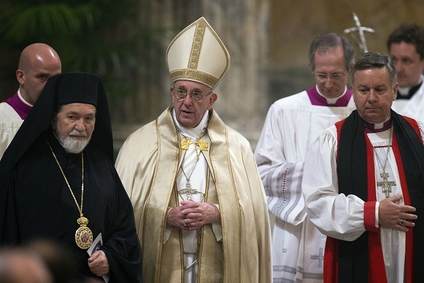 Pope Francis is flanked by Ortodox Primate of the Metropolis of Italy Gennadios Zervos, left, and the representative of the Archbishop of Canterbury to the Holy See David Moxon, at the end of the second Vespers prayer in St. Paul Outside the Walls Basilica on the occasion of the liturgical Feast of the Conversion of St. Paul the Apostle, in Rome, Monday, Jan. 25, 2016. (AP Photo/Andrew Medichini)