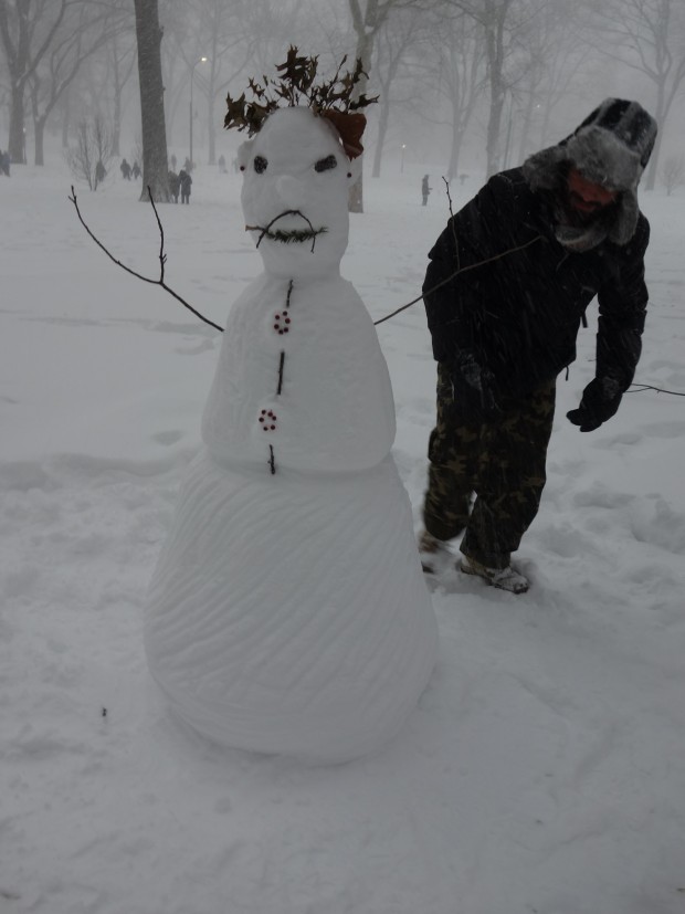 The snowman in Saturday afternoon Central Park took 45-60 minutes to build.  Its maker is also pictured