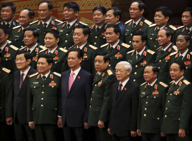 Vietnamese President Truong Tan Sang, front row left, Prime Minister Nguyen Tan Dung, front row third left, and Communist Party General Secretary Nguyen Phu Trong, front row third right, pose for a group photo with the Army generals after the election for the new Central Committee in Hanoi, Vietnam, Tuesday, Jan. 26, 2016. Trong secured more than 80 percent of the votes from delegates at a party congress to win election to the Central Committee, one of the two pillars of the ruling establishment, several delegates said. (AP Photo/Na Son Nguyen)