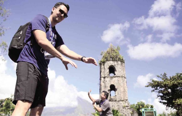 TRICK SHOT Tourist guides in the Cagsawa Ruins in Daraga, Albay province, take “trick shots” of visitors like this one for their souvenir poses. MARC ALVIC ESPLANA / INQUIRER SOUTHERN LUZON