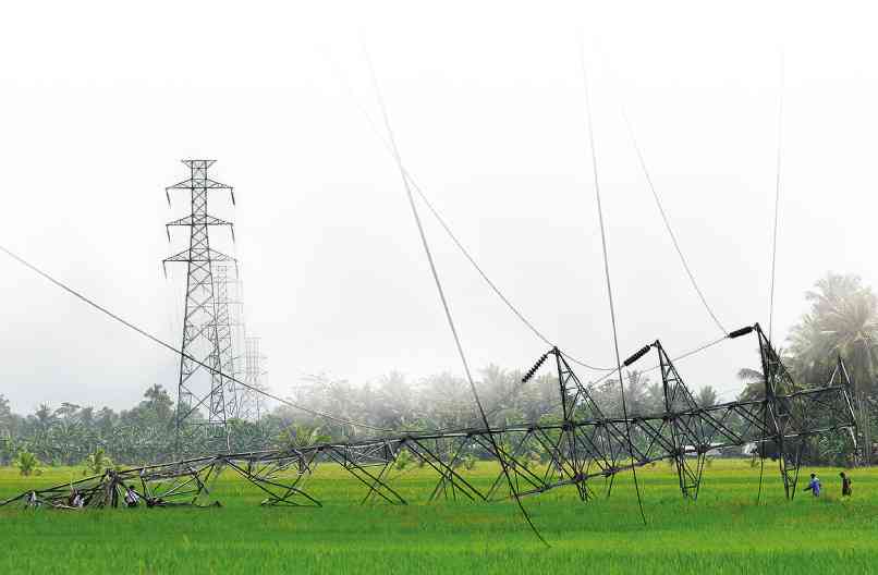 THE BOMBING of transmission towers has succeeded in toppling this tower in September 2013 in North Cotabato province, causing massive outages there and in two other provinces—Sultan Kudarat and Maguindanao.         CONTRIBUTED PHOTO 