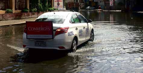 A TAXI cab makes like an amphibian vehicle as it wades out into flooded Maysilo Circle in Mandaluyong City. JOVIC YEE