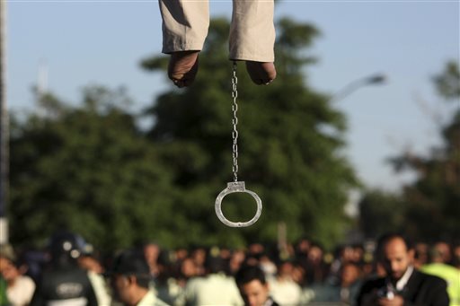 In this May 26, 2011 file photo, the feet of convicted man Mahdi Faraji, is seen with shackle, while he is being hanged, at the city of Qazvin about 80 miles (130 kilometers) west of the capital Tehran, Iran. Dozens of people who were arrested in Iran for crimes committed before they were 18 remain at risk of the death penalty despite recent reforms, with many having already spent years on death row, according to a report by Amnesty International released Tuesday, Jan. 26, 2016. (AP Photo/Mehr News Agency, Hamideh Shafieeha, File)