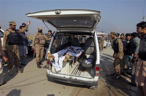 Pakistani troops clear way for an ambulance transporting a lifeless body of a victim from Bacha Khan University in Charsadda town, some 35 kilometers (21 miles) outside the city of Peshawar, Pakistan, Wednesday, Jan. 20, 2016. Gunmen stormed Bacha Khan University named after the founder of an anti-Taliban political party in the country's northwest Wednesday, killing many people, officials said. AP PHOTO