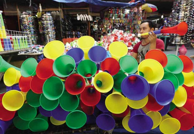 SAFER WAY TO GREET NEW YEAR Colorful plastic horns go on sale on Carriedo Street in Quiapo, Manila, in time for the New Year. MARIANNE BERMUDEZ
