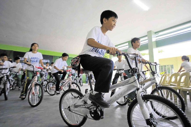 BIKE TO SCHOOL Students in Albay try out the bikes donated to them so they can get to school without the long hike from their homes. MARK ALVIC ESPLANA / INQUIRER SOUTHERN LUZON