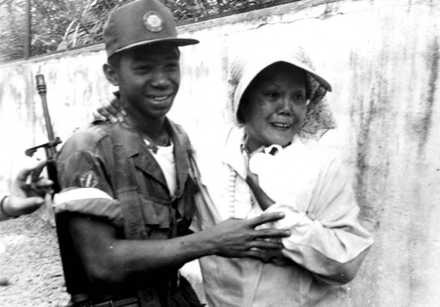 PEOPLE POWER EDSA 1 / FEBRUARY 24 1986 / SAVED IN PDI ARCHIVE An unidentified woman hugs a government soldier who surrendered after a firefight against reformist troops who took over channel 4, a government-run TV station, and cutting off Marcos's televised speech during the 1986 People Power Revolution.  PDI PHOTO / ROGER CARPIO