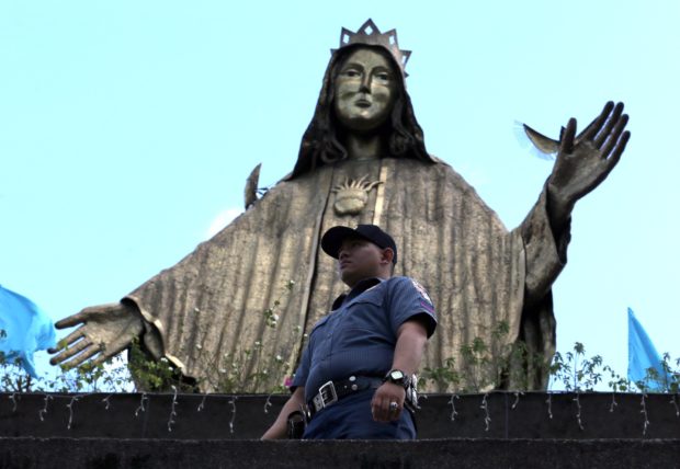 Cop guards Edsa Shrine