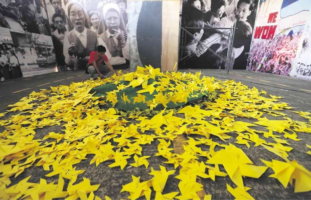 FLOWER POWER  Yellow paper flowers are arranged at a hall of the People Power Experiential Museum in Quezon City showing photos of scenes during the mass uprising on Edsa that toppled the Marcos dictatorship. JOAN BONDOC