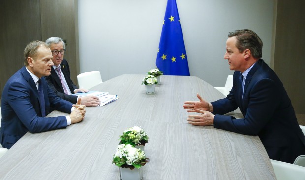 European Council President Donald Tusk, left, and European Commission President Jean-Claude Juncker, second left, participate in a meeting with British Prime Minister David Cameron during an EU summit in Brussels on Friday, Feb. 19, 2016. European Union leaders are holding a summit in Brussels on Thursday and Friday to hammer out a deal designed to keep Britain in the 28-nation bloc.  (Yves Herman, Pool Photo via AP)
