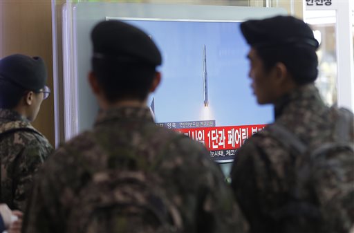South Korean army soldiers watch a TV news program with a file footage about North Korea's rocket launch at Seoul Railway Station in Seoul, South Korea, Sunday, Feb. 7, 2016. North Korea on Sunday defied international warnings and launched a long-range rocket that the United Nations and others call a cover for a banned test of technology for a missile that could strike the U.S. mainland. (AP Photo/Ahn Young-joon)