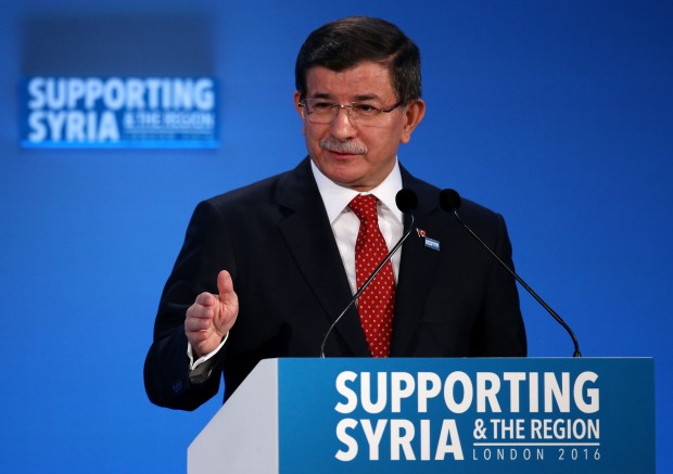 Turkey's Prime Minister Ahmet Davutoglu  speaks at the 'Supporting Syria and the Region' conference at the Queen Elizabeth II Conference Centre in London, Thursday, Feb. 4, 2016.  Leaders and diplomats from 70 countries are meeting in London Thursday to pledge billions to help millions of Syrians displaced by war, and try to slow the chaotic exodus of refugees to Europe. (Dan Kitwood Pool via AP)