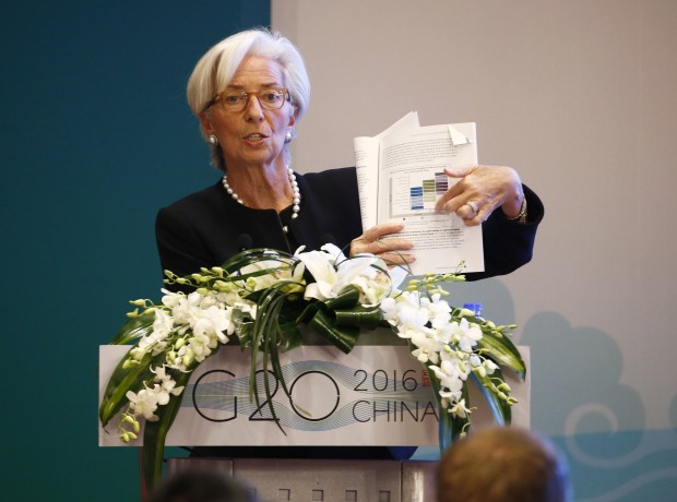 International Monetary Fund (IMF) Managing Director Christine Lagarde holds a document report while speaking during a session of the G20 High-Level Seminar on Structural Reform, proceeding the G20 Finance Ministers and Central Bank Governors Meeting at the Pudong Shangri-la Hotel in Shanghai, China, Friday, Feb. 26, 2016.  (Rolex Dela Pena/Pool Photo via AP)