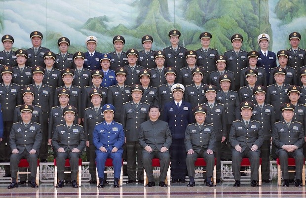 In this photo provided by China's Xinhua News Agency, Chinese President Xi Jinping, center front, poses for a group photo during a meeting with the new heads of the reorganized organs of the Communist Party's Central Military Commission in Beijing, Monday, Jan. 11, 2016. AP