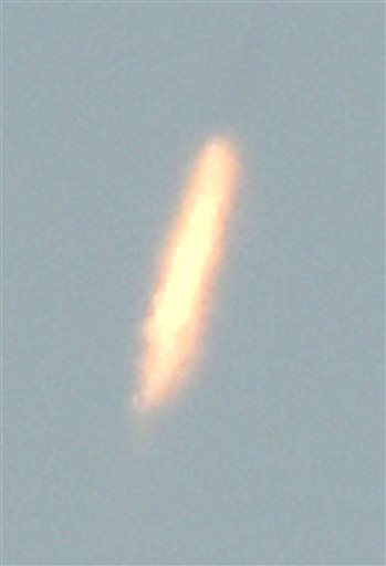 In this image released by Japan's Kyodo News agency, an unidentified object is photographed in the sky from Dandong, China, near the North Korean border, Sunday, Feb. 7, 2016, at the same time a North Korea rocket was allegedly launched. North Korea on Sunday defied international warnings and launched a long-range rocket that the United Nations and others call a cover for a banned test of technology for a missile that could strike the U.S. mainland. (Minoru Iwasaki/Kyodo News via AP) JAPAN OUT, MANDATORY CREDIT