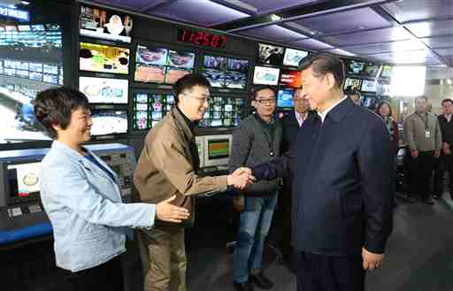 In this photo released by China's Xinhua News Agency, Chinese President Xi Jinping, right, shakes hands with staff members at the control room of China Central Television (CCTV) in Beijing, Friday, Feb. 19, 2016. Chinese President Xi Jinping made a rare, high-profile tour of the country's top three state-run media outlets Friday, telling editors and reporters they must pledge absolute loyalty to the party and closely follow its leadership in "thought, politics and action." AP