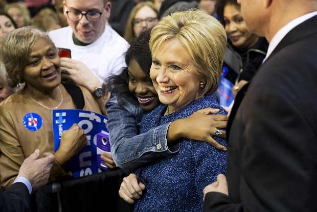 Democratic presidential candidate, Hillary Clinton, right, is embraced by an audience member while posing for a photo at a campaign event at Miles College Saturday, Feb. 27, 2016, in Fairfield, Ala. (AP Photo/David Goldman)
