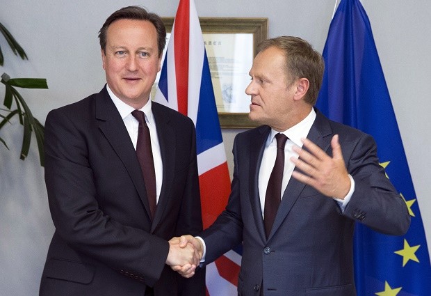FILE - In this June 25, 2015 file photo, British Prime Minister David Cameron, left, shakes hands with European Council President Donald Tusk during a meeting on the sidelines of an EU summit in Brussels. European Council President Donald Tusk on Tuesday, Feb. 2, 2016 unveiled proposals that he hopes will keep Britain in the 28-nation European Union. The draft deal was made public in a letter to EU leaders. It must be endorsed by Britain's EU partners and is set to be thrashed out at a summit in Brussels on Feb. 18. (Julien Warnand/Pool Photo via AP)