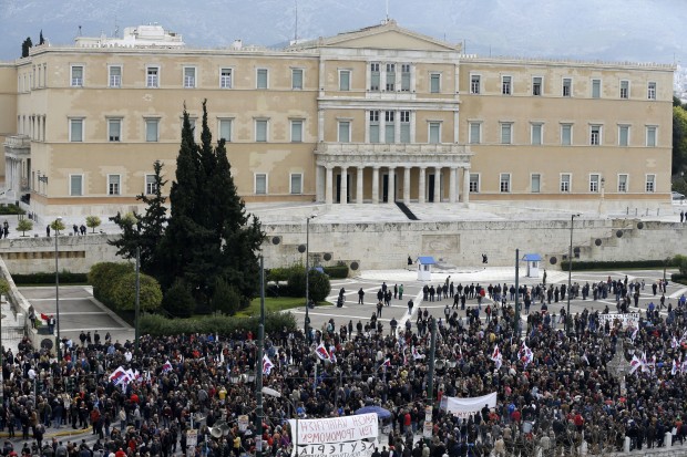 Protesting members of the PAME Communist-affiliated gather outside the Greek Parliament during a 24-hour nationwide general strike in Athens, Thursday, Feb. 4, 2016. Unions called the strike to protest pension reforms that are part of Greece's third international bailout. The left-led government is trying to overhaul the country's ailing pension system by increasing social security contributions to avoid pension cuts, but critics say the reforms will lead many to lose two-thirds of their income to contributions and taxes. (AP Photo/Thanassis Stavrakis)